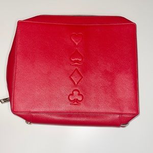 Estee Lauder travel bag red card suits design on front with handle on top.